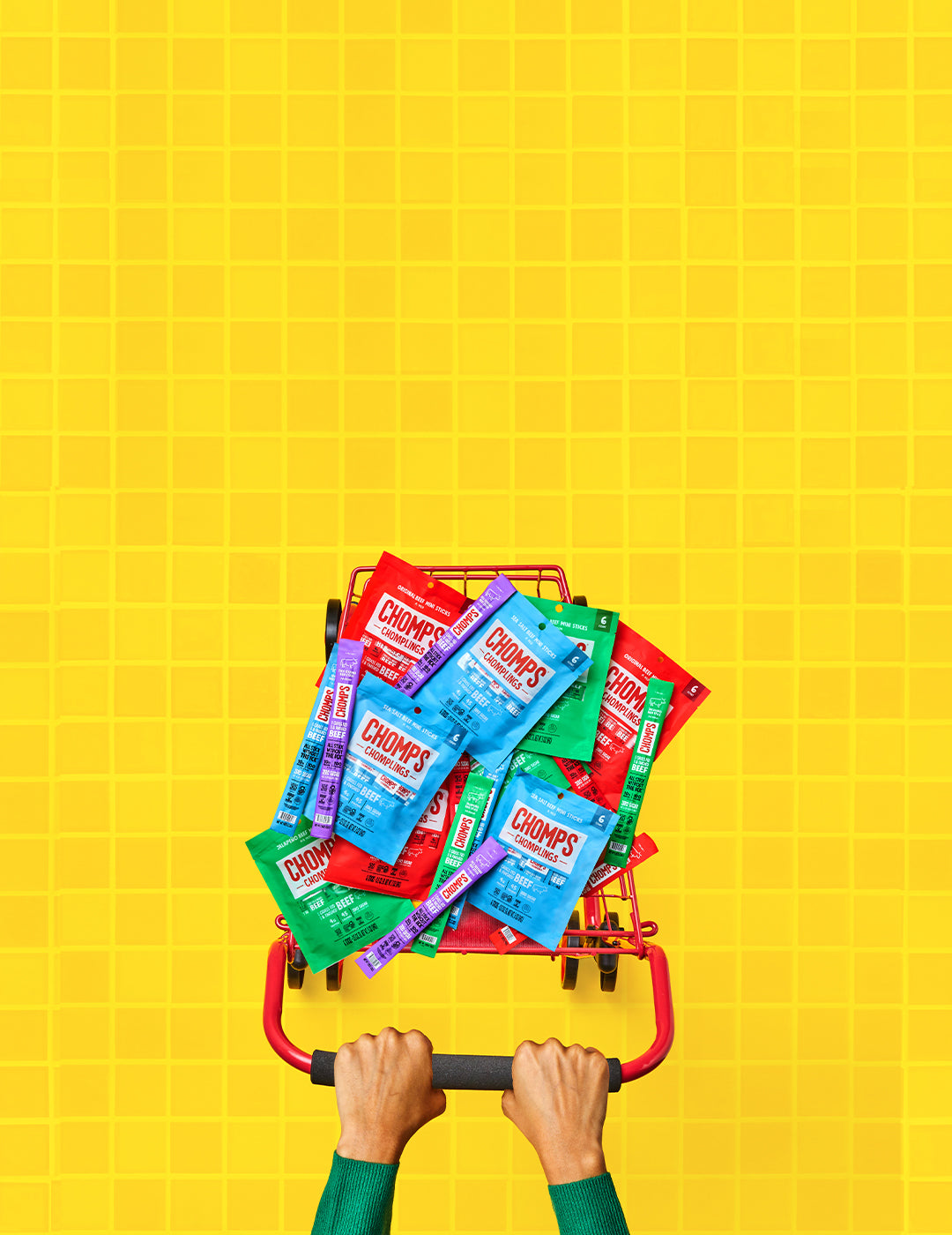 An image of a person pushing a shopping cart full of Chomps.