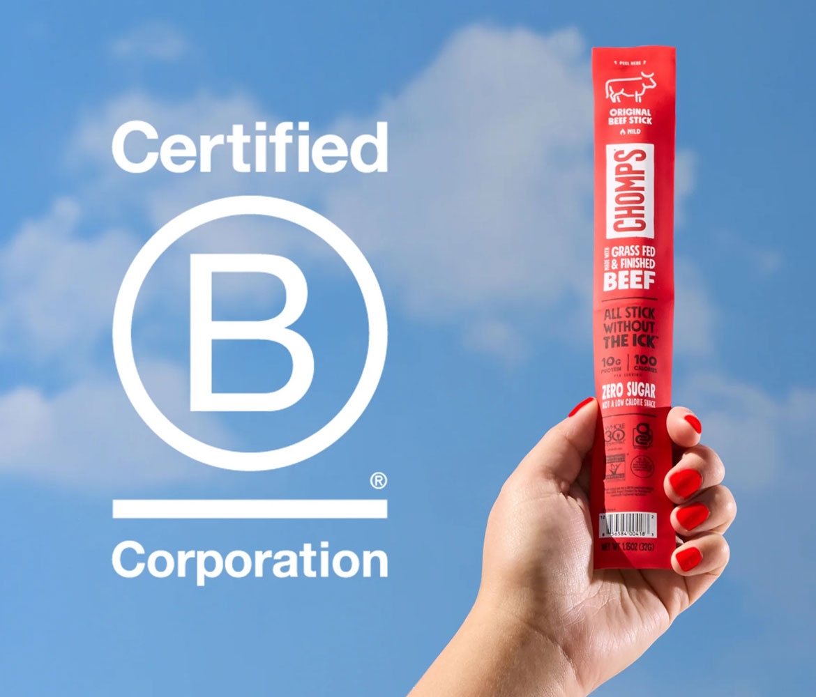 A hand with red nail polish holds a red Chops Original Beef stick against a blue sky background with clouds. Large white text on the left reads 'Certified B Corporation'.