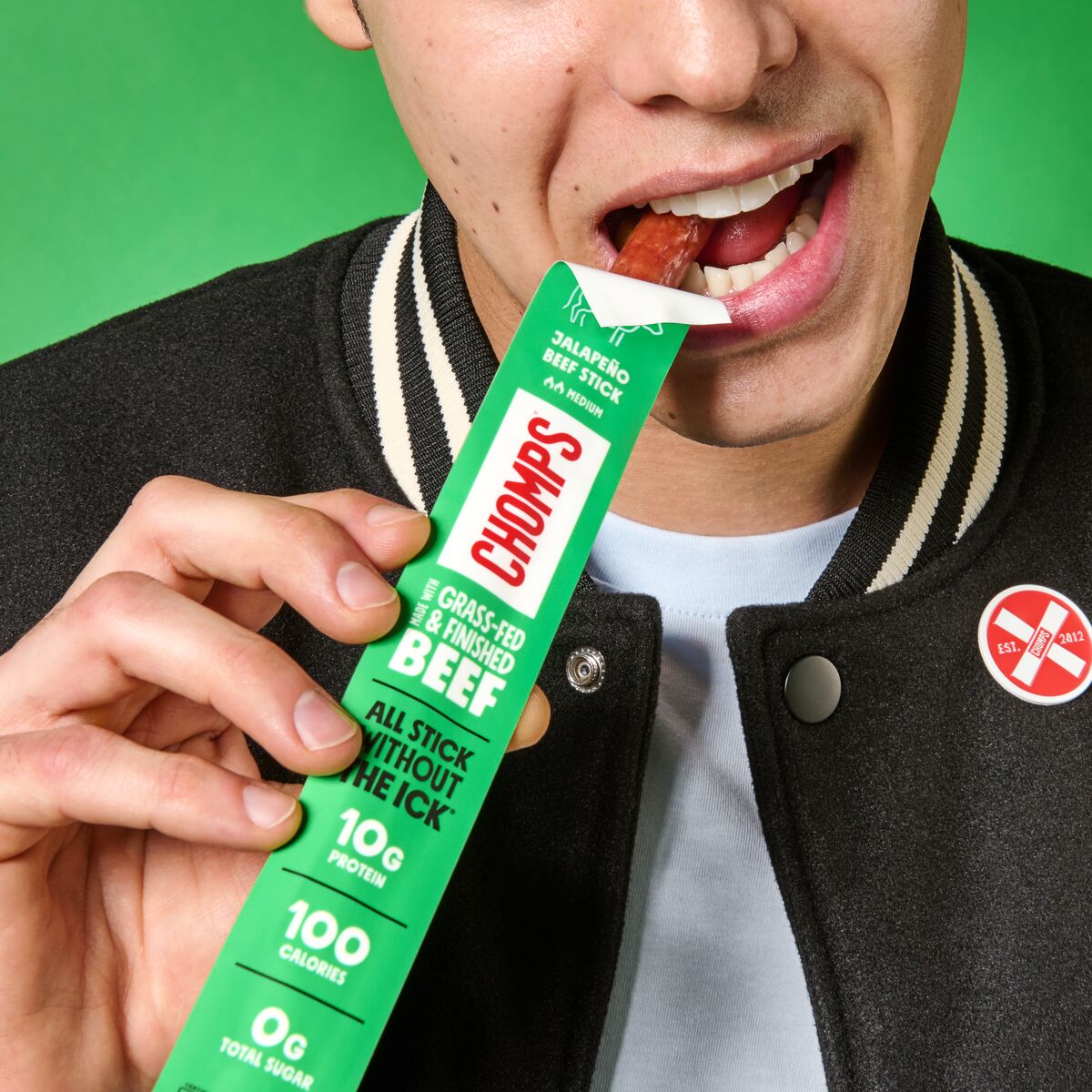 A man eating CHOMPS jalapeño beef sticks