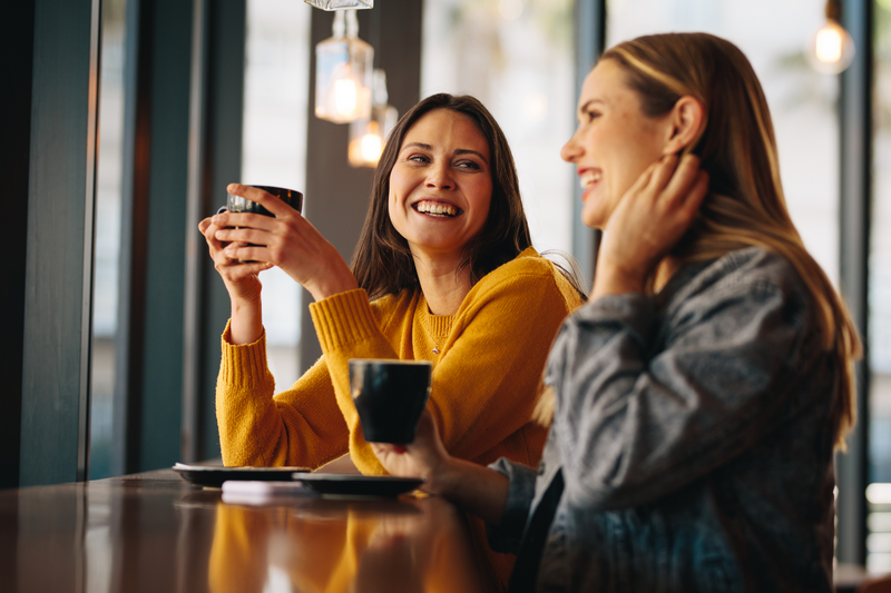 Women Chatting with Tea at Cafe