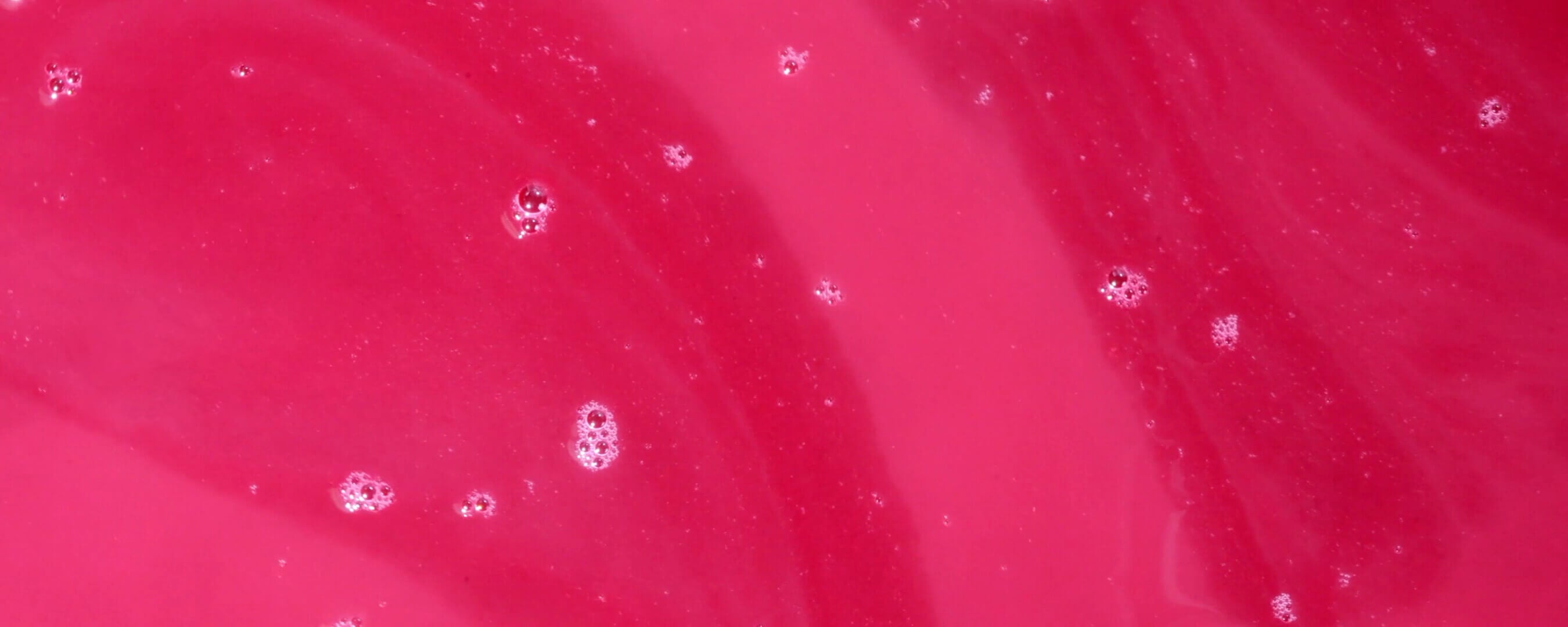 Close-up of red liquid with bubbles