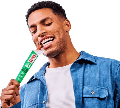 Man eating a Chomps beef stick