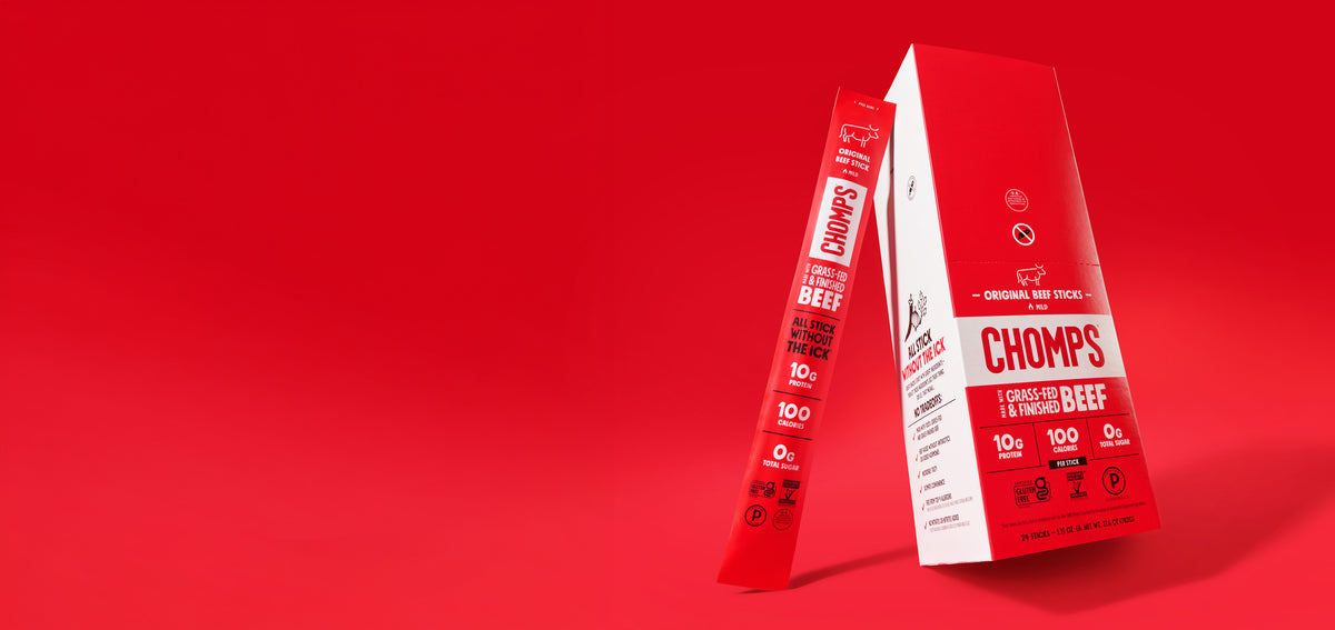 Red and white packaging for Chomps Grass-Fed & Finished Beef Sticks, showing a tall box and a single stick package on a solid red background.