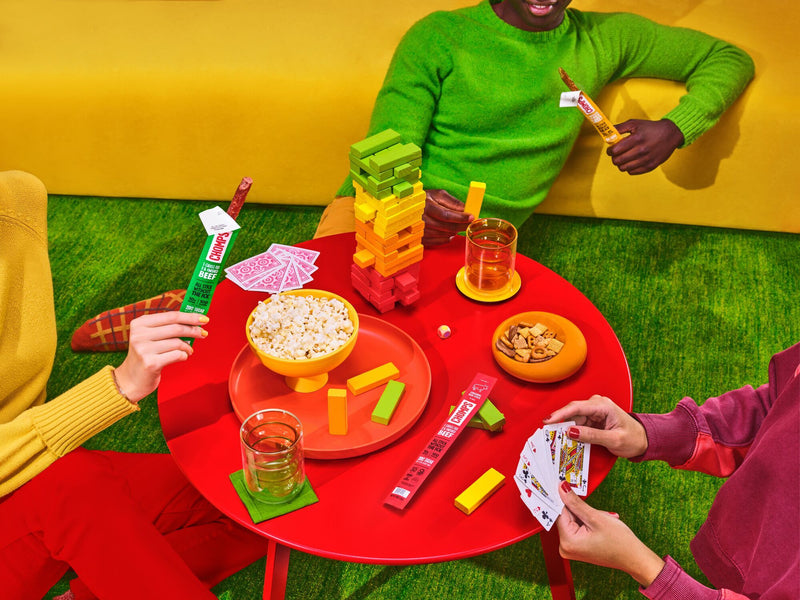 People playing cards and eating Chomps