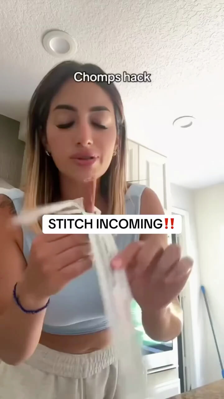 A woman in a light blue crop top holds up a Chomps stick , with text overlays reading 'Chomps hack' and 'STITCH INCOMING !!'.